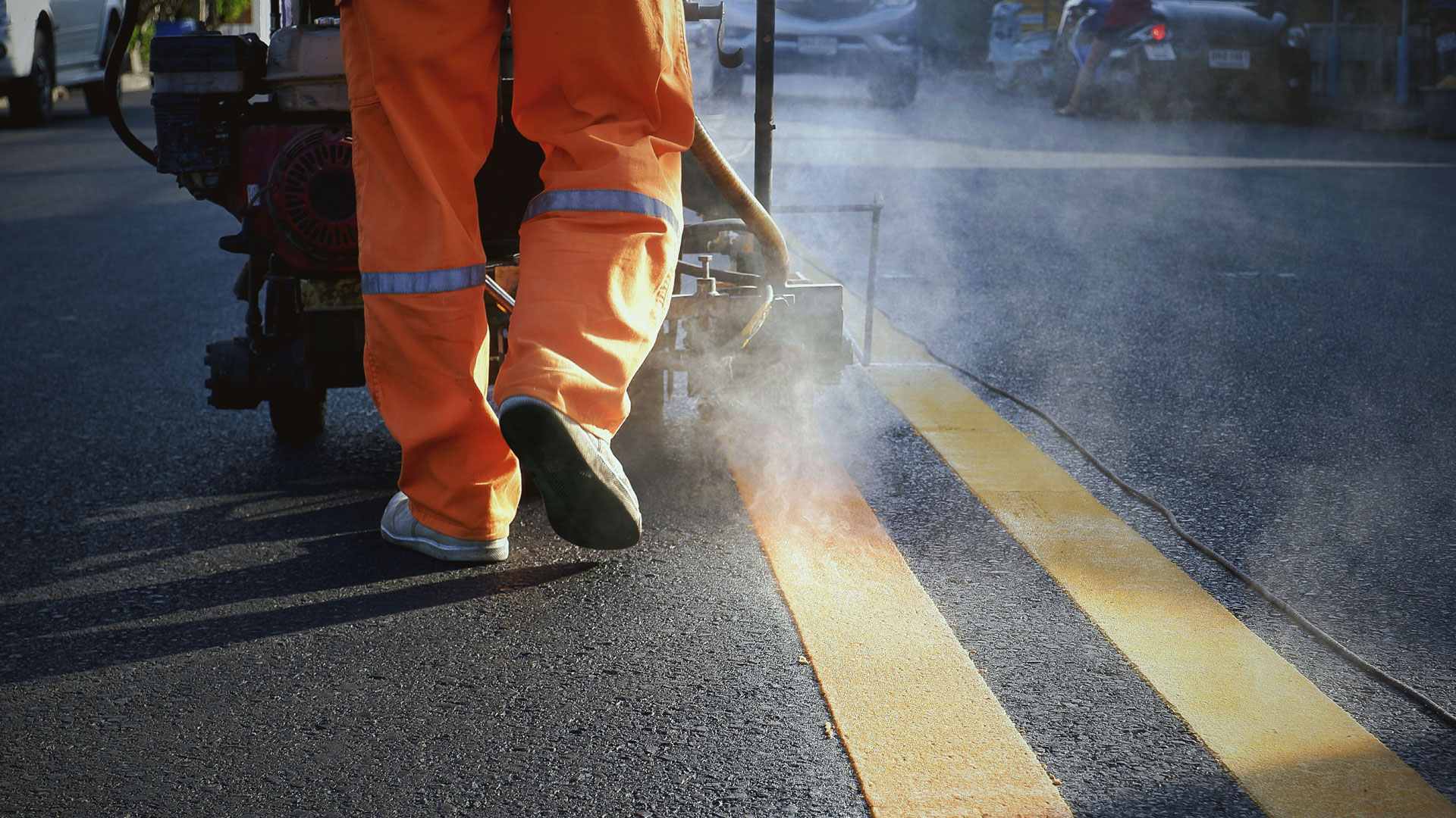 Worker applying road markings