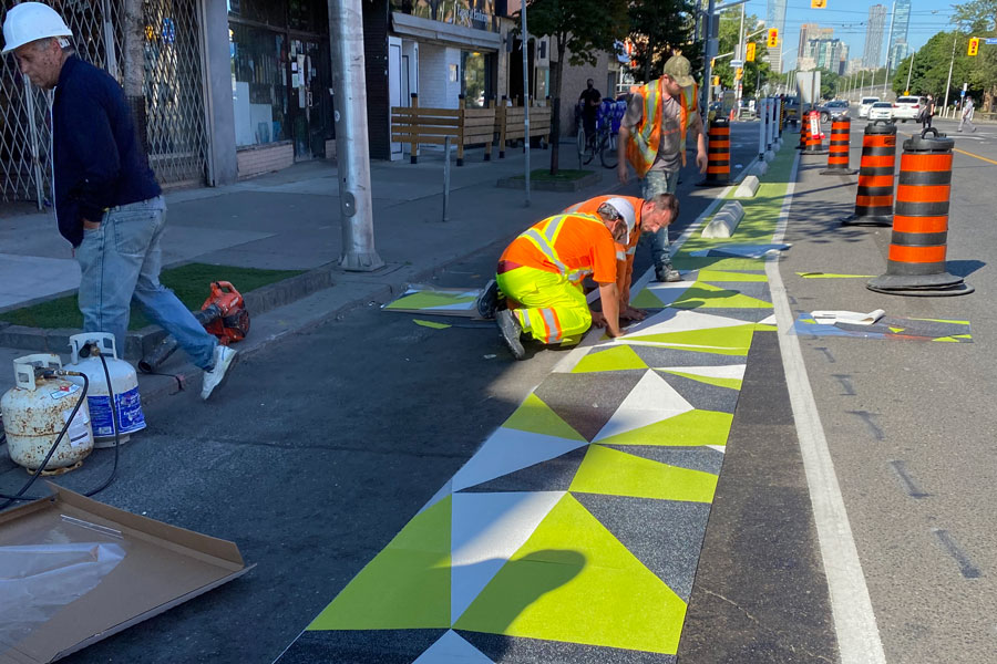 Workers installing road graphics